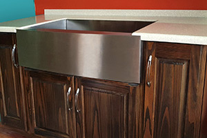 Apron/Farmhouse Sink, for those large wares, installed in a Walnut-stained Cabinet.