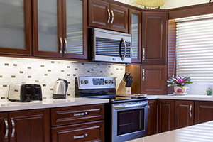 Appamat Balandra Kitchen in General Finishes Brown Mahogany Stain and paired with Stainless Steel Pulls