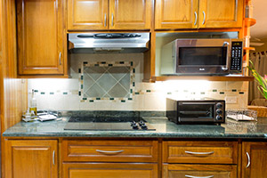 Teak Blanchisseuse Kitchen in General Finishes Golden Pecan Stain with Stainless Steel Pulls